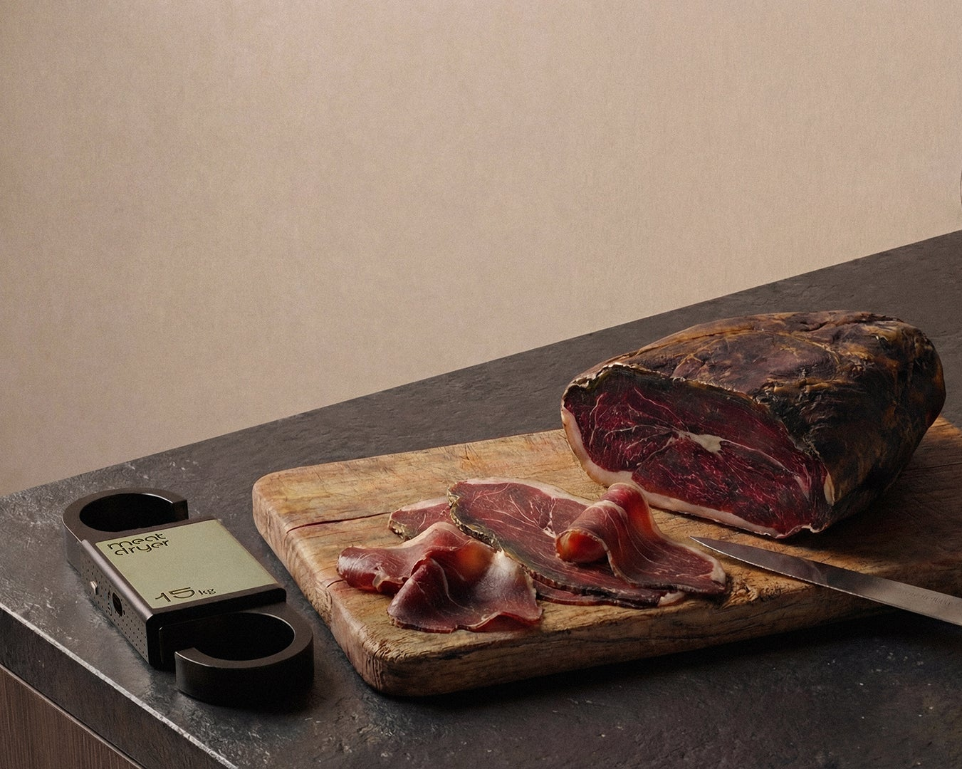 Sliced cured meat on a wooden cutting board with a meatdryer digital thermometer,  humidity meater and smart weight scale on a dark surface.